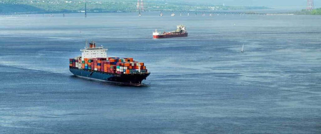 Two cargo ships coming into a port